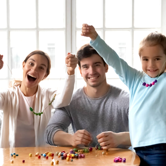 Happy family celebrating Mother's Day with handmade jewelry