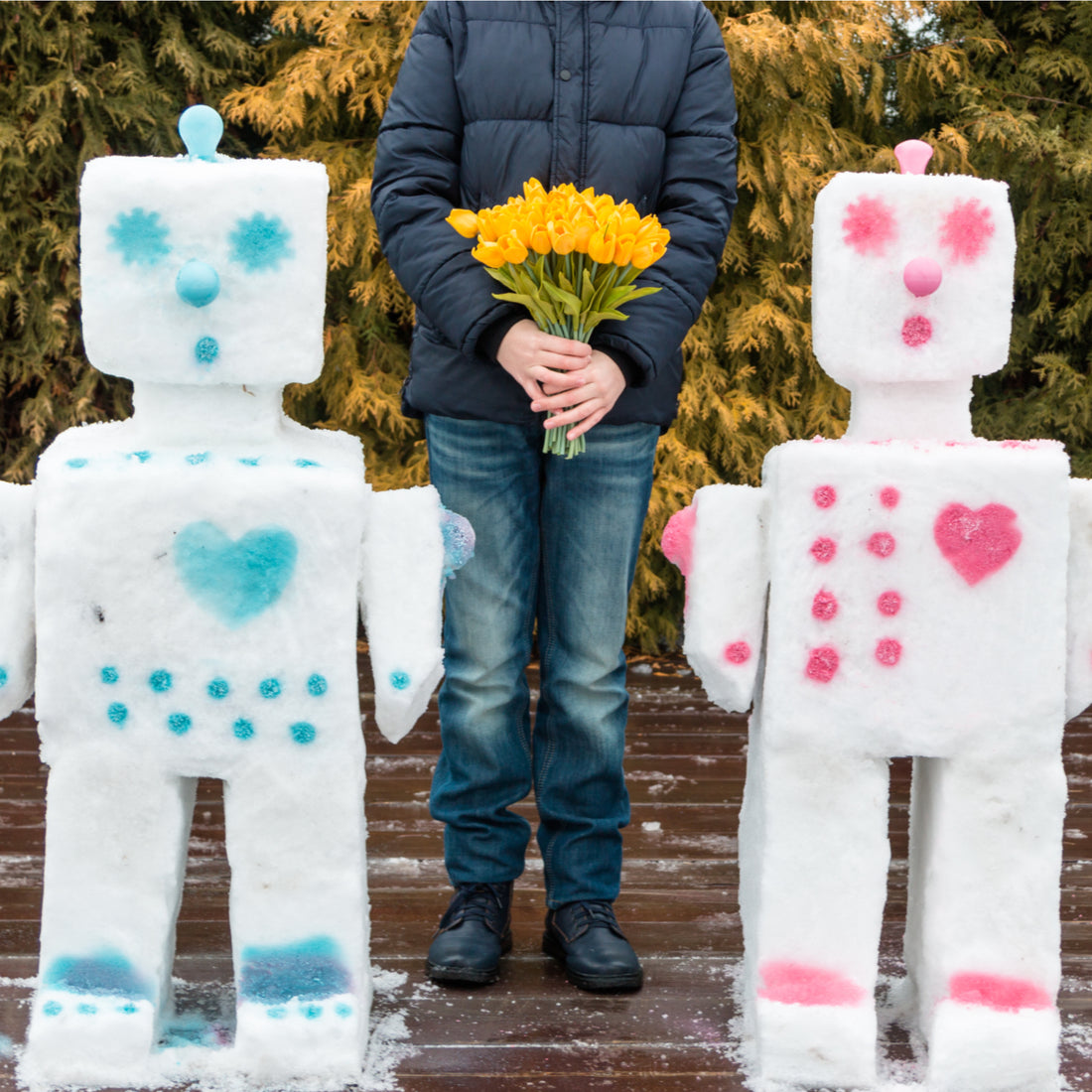 Valentine's day snowman and snowwoman standing by a man with flowers